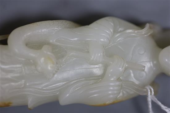 A fine Chinese white and russet jade group of Xi Wangmu and a phoenix, 19th/20th century, 9.5cm high, wood stand